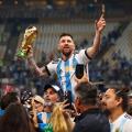 LUSAIL CITY, QATAR - DECEMBER 18: Lionel Messi celebrates with the World Cup Trophy after the FIFA World Cup Qatar 2022 Final match.