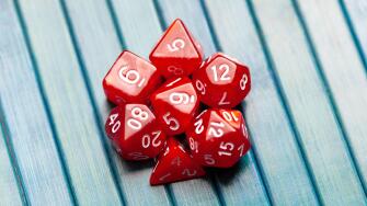 Lots of simple red RPG game dice, polyhedral dice set for role playing games and scenarios, top view. Dices group closeup. Tabletop board games