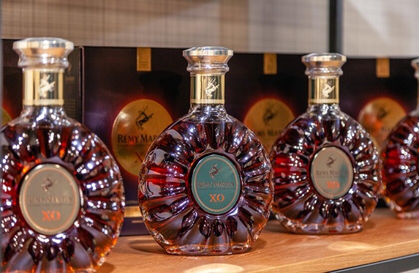 Russia Kemerovo 16-11-2018 degustation luxury vip cognac Remy Martin XO in crystal bottles stands in line on wooden shelves. The concept of advertisin