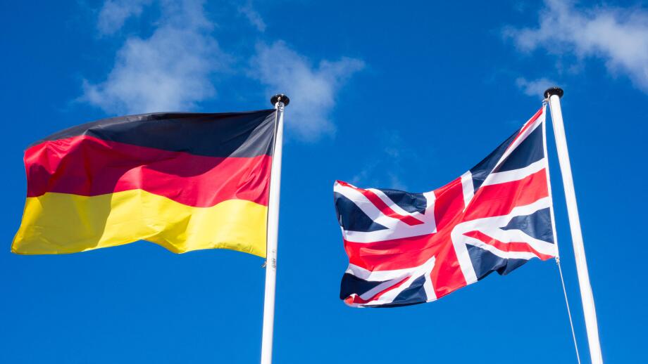Flags of Germany and United Kingdom against blues sky