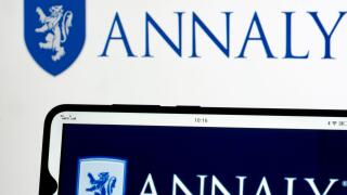 In this photo illustration Annaly Capital Management, Inc. logo seen displayed on a smartphone and in the background.
