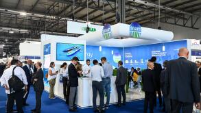 MILAN, ITALY - SEPTEMBER 6, 2022: a view of the Snam stand during Gastech 2022 trade show event in Milan Fair. Visitors and people in the hall walk through exhibitors stands and exhibit booths.