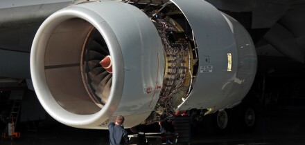 A technician carries out maintenance on a Rolls-Royce Trent 500 aircraft jet engine. Aviation engineering, knowledge workers, skilled workforce.