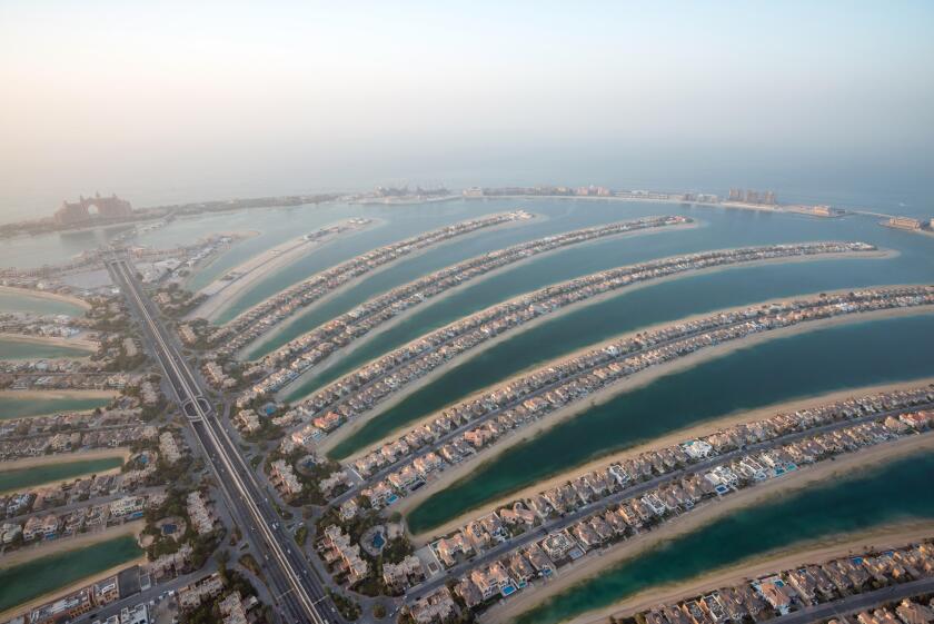 Aerial photo of The Palm Jumeirah in Dubai, UAE at dusk