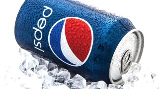 Can of Pepsi cola on a bed of ice and white background, Pepsi is a carbonated soft drink produced PepsiCo, Created in 1893