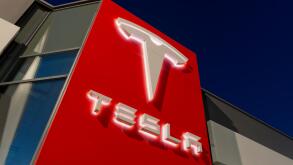 Signage for the Tesla motor company at nigtht outside one of its showrooms in South Manchester, UK.