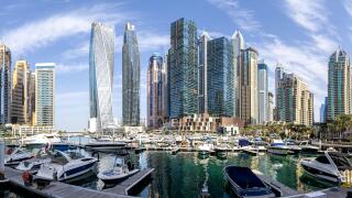 Dubai Marina skyline cityscape with yachts skyscraper real estate buildings living at water panorama boats