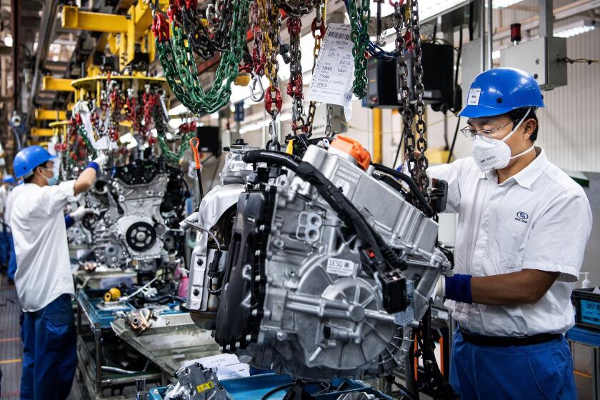 Wuhan, China. 18th May, 2022. Employees wearing masks work on a car assembly line at the SAIC General Motors Co. The SAIC General Motors Wuhan Branch has resumed production following epidemic prevention and control rules. The SAIC General Motors Wuhan Bra