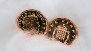 Two copper penny coins in close up wrapped in cotton wool for protection. Protecting money and austerity concept. UK