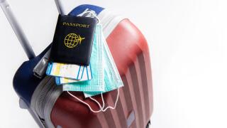 Travel suitcase / luggage, passport, air ticket and mask. Travel ban during the pandemic of  coronavirus or covid-19