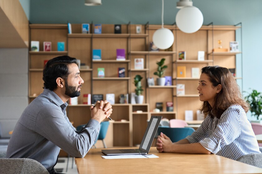 Indian hr employer listening latin candidate at job interview meeting.