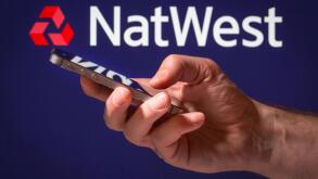 A man using Natwest online banking on his mobile phone