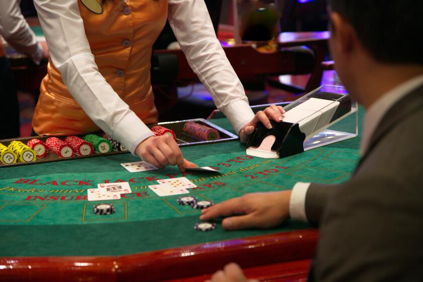 Dealer puts down a card on blackjack table