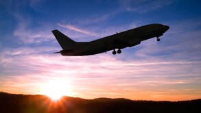 Airplane Taking Off into a Sunset.
