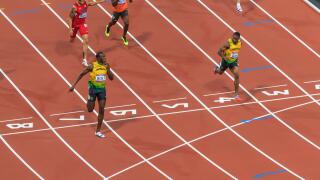 Usain Bolt crosses line with finger to lips, looks at Yohan Blake, Men's 200m final, London 2012, Olympic Games, London, UK