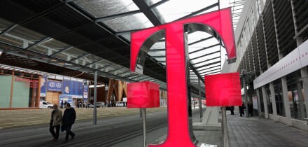 Germany Hanover  2008 - Fairgoers walk past logo of German telecommunications giant Deutsche Telekom at CeBIT Trade Fair
