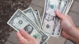 dollar notes hands_7Feb23