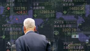 TOKYO, Japan - An electronic signboard in central Tokyo's Yaesu district displays the Nikkei Stock Average (top C) and foreign stock indexes on the afternoon of June 25, 2013. Tokyo stocks ended lower as sentiment was dented by tumbling Chinese shares, am