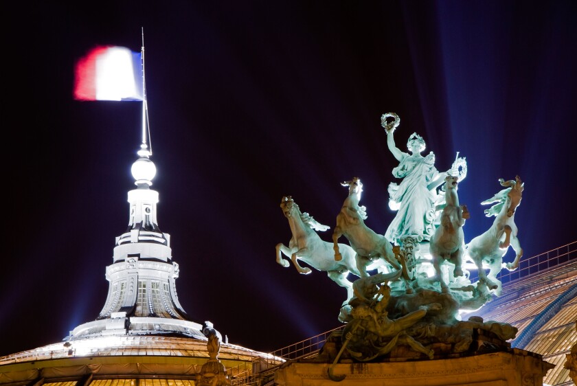 Statue and French flag on the roof of the Grand Palais at night, Paris, France, Europe