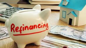 Refinancing written on a piggy bank.