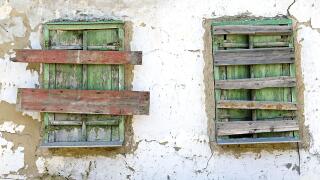 two old boarded-up window on the wall. Image shot 10/2019. Exact date unknown.