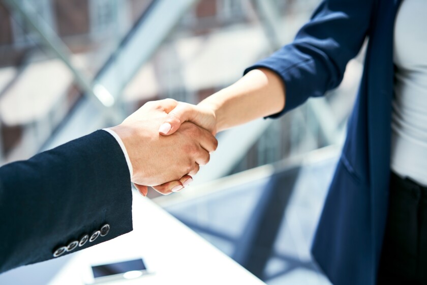 Close-up of handshake of businesswoman and businessman