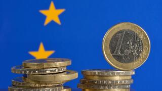 Euro coins with an European flag, symbolic image for the euro crisis