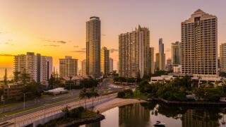 A spectacular sunrise illuminates the Surfers paradise high-rise apartments with beautiful golden light.bordering the ocean and the canal development.
