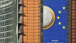 Banner about the euro hanging from building of the European Commission, executive body of European Union in Brussels, Belgium