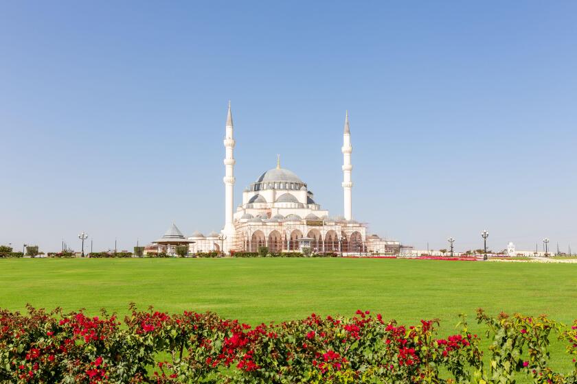 New Sharjah Mosque (Sharjah Masjid), the largest mosque in the Emirate of Sharjah, the United Arab Emirates, white sandstone facade with domes.