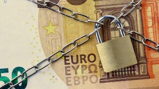 Closeup of 50 euro banknote locked with chain and padlock - Conc
