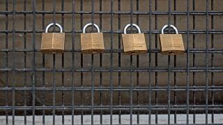 Four Master padlocks on a grill.