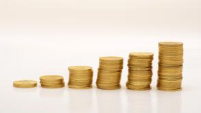 Stack of Golden Coins on White background with reflection.