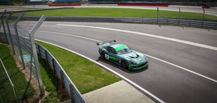A racing car entering the pits on a track day at Silverstone Racing Circuit, Towcester, England.