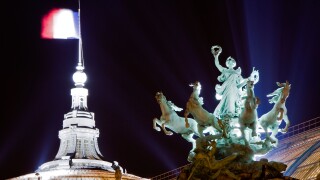 Statue and French flag on the roof of the Grand Palais at night, Paris, France, Europe