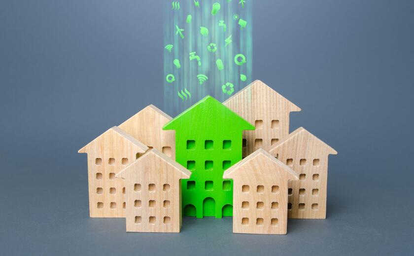 Green building stands out among the houses. Renovation and environmental improvement of old buildings. Net Zero Carbon neutrality. Environmentally fri