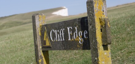 Cliff Edge sign on Beachy head coastline East Sussex England UK