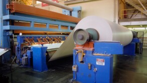 Used paper enters Smurfitt Paper company as waste, leaves as new paper eight hours later. Pomona, California USA