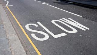Close-Up of road marking saying Slow in London, UK