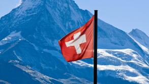 swiss flag in front of the matterhorn