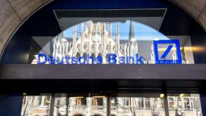 Deutsche Bank logo on the window of a branch in Munich