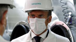 French President Emmanuel Macron, wearing a protective face mask, visits a site of pharmaceutical group Seqens, a global leader on the production of active pharmaceutical ingredients, to mobilize innovation and support the research on the coronavirus dise