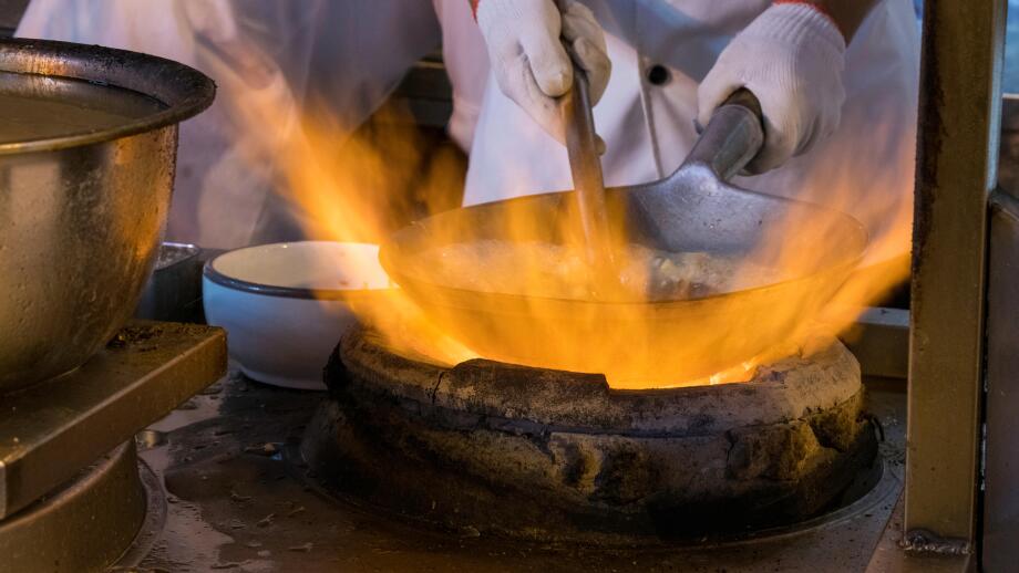 Wok cooking, flash in the pan, fire flames