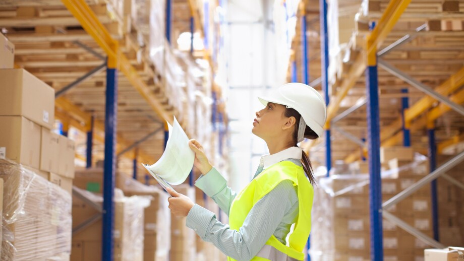 Female warehouse worker checking stock