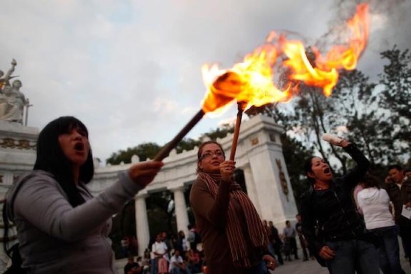 Demonstrators light fire during a protest against a subway fare hike at Hemiciclo de Juarez monument in Mexico City December 13, 2013. Mexico City authorities raised the subway's fare from 3 to 5 pesos starting from Friday, according to local media. REUT