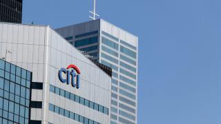 The Citi bank, Citigroup logo atop of an office building in downtown Toronto, seen on a clear and blue sky day.