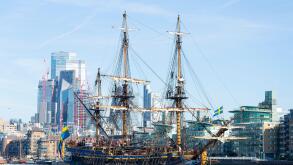 Gotheborg of Sweden, a sailing replica of the Swedish East Indiaman Gotheborg I, visiting London, UK. London city skyline, financial district