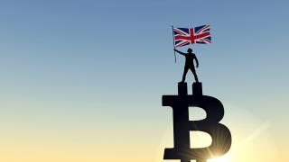 Person waving a UK flag standing on top of a bitcoin cryptocurrency symbol. 3D Rendering