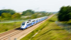 A double-decker TGV Duplex high speed train in Atlantic livery from french company SNCF driving at full speed in the countryside (with motion blur).