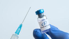 Vials of liquid on a white table and the logo Danaher Corporation, large pharmaceutical company. March 15, 2021. Barnaul, Russia.